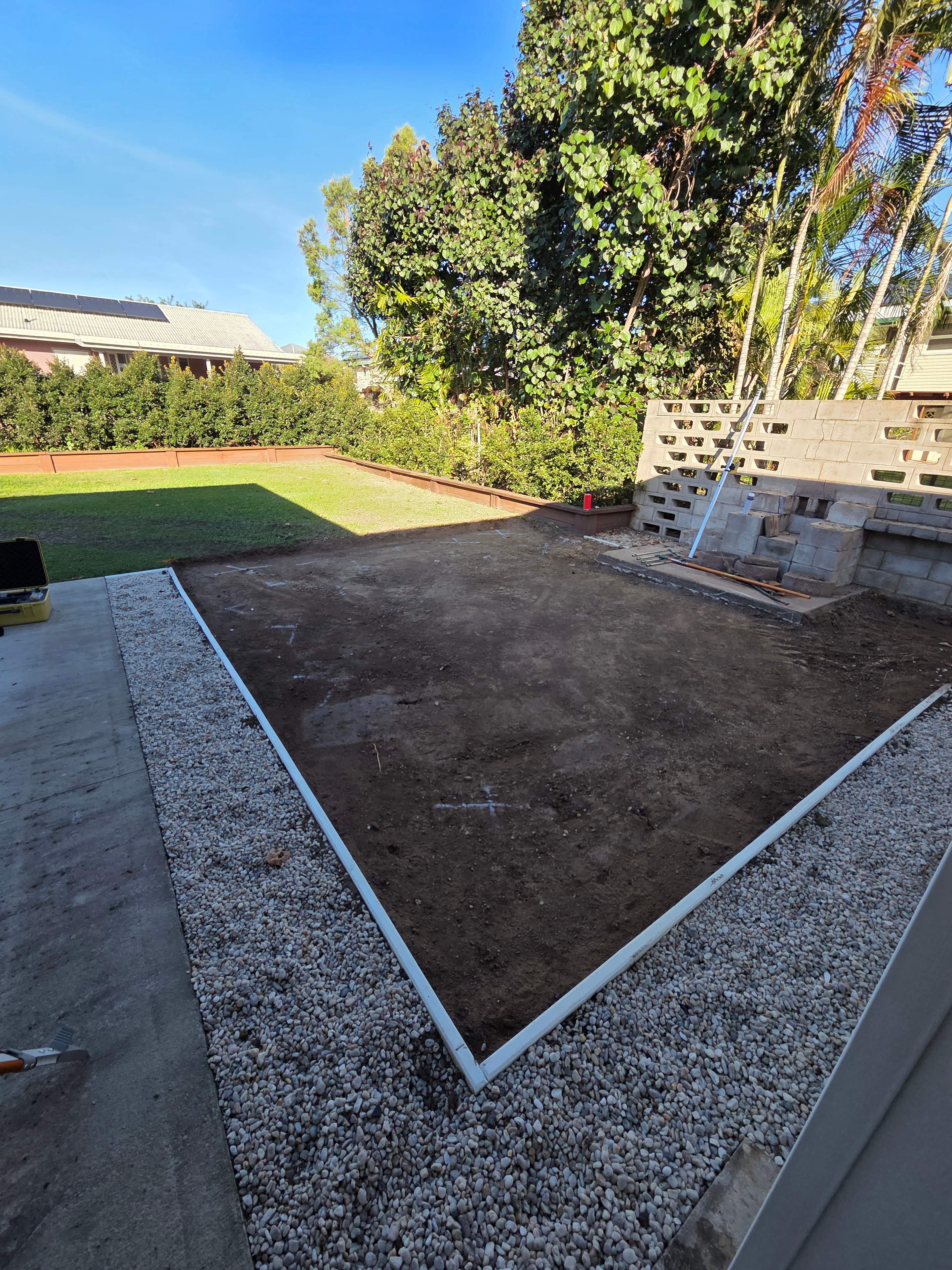 Gravel driveway and concrete edging construction at residential property