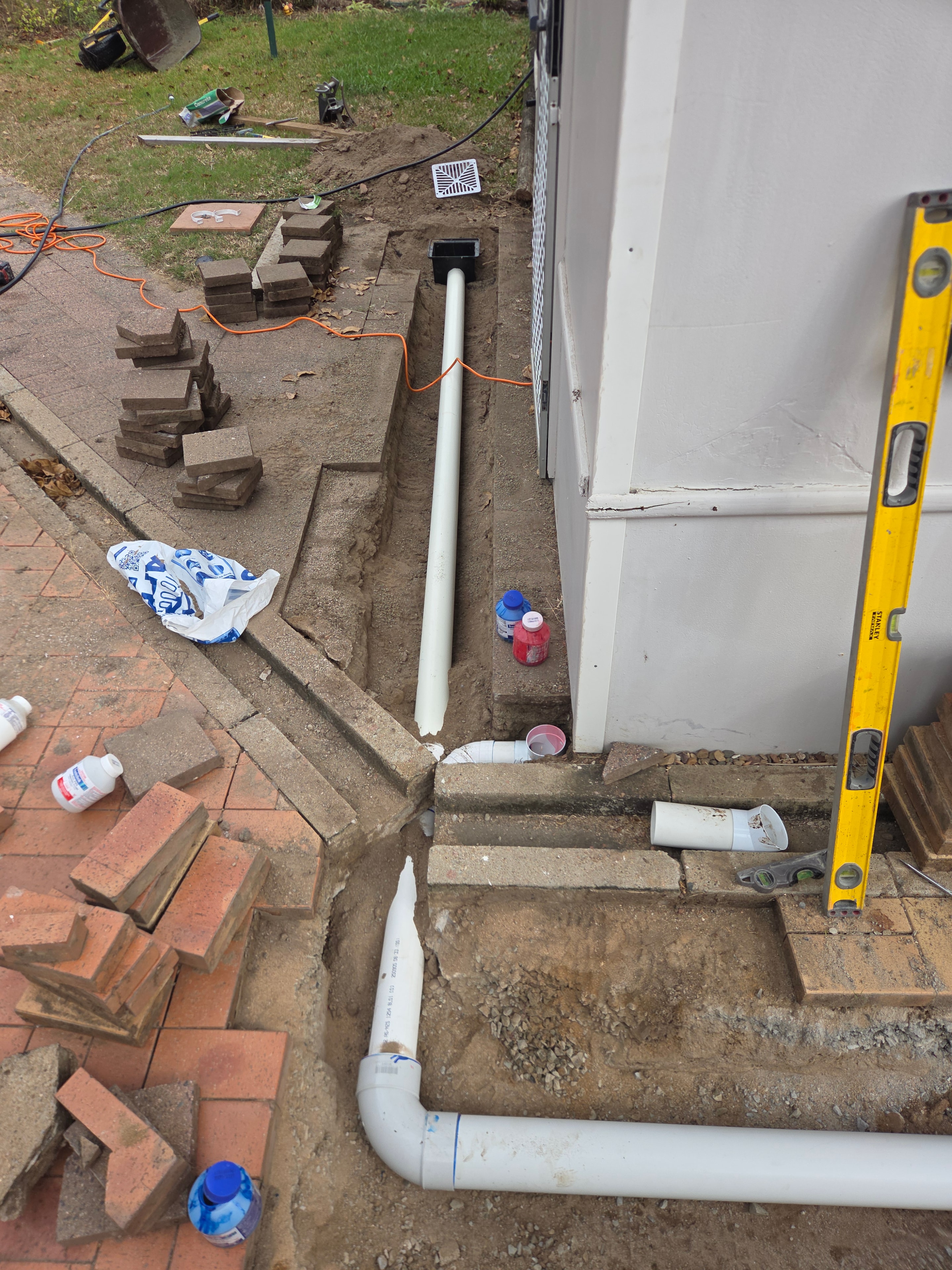 Residential drainage pipe installation with PVC pipes and level check