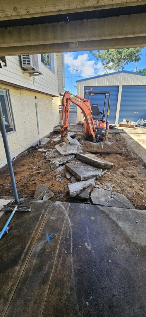Excavator working under residential building